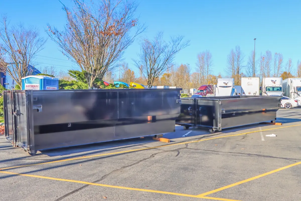 Professional dumpster rental service with roll-off container on residential driveway in Pukalani